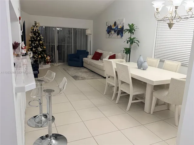 a living room with furniture and flowers