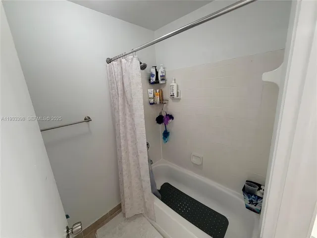 a bathroom with a bathtub and shower