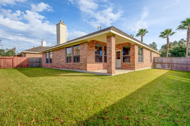 a view of a house with a backyard and plants