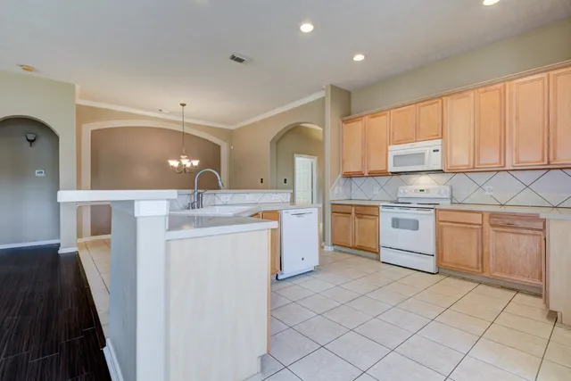 a kitchen with a sink stove and cabinets