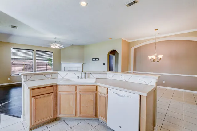 a kitchen with a sink stove and cabinets