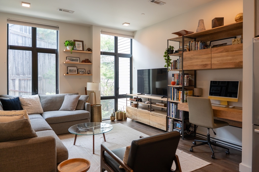 2 Sinclair Road, Unit 202 Boston, MA 02134 - Photo 6 of 23 a living room with furniture fireplace and a large window