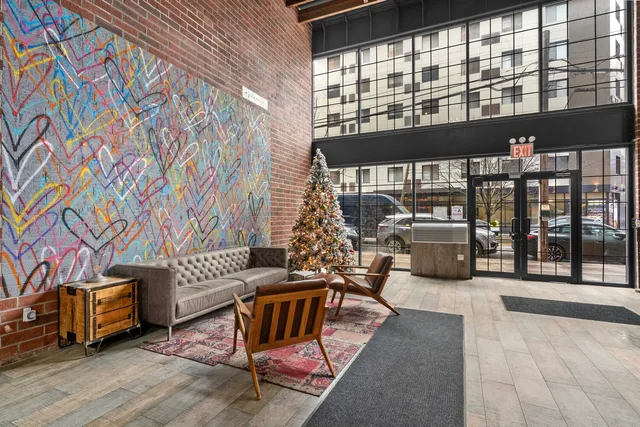 a living room with furniture and a floor to ceiling window