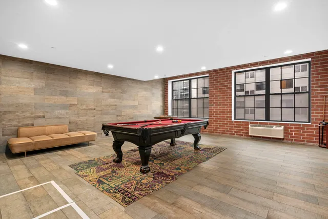 a living room with furniture a table and a large window