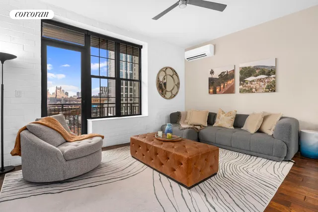 a living room with stainless steel appliances kitchen island granite countertop furniture and a view of kitchen