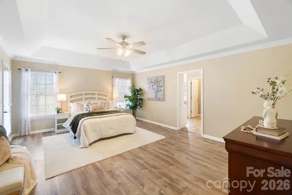 a bedroom with a large bed and wooden floor