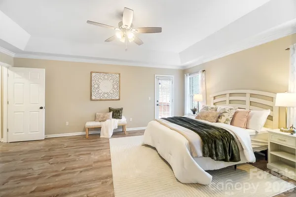 a bedroom with a bed and a chandelier