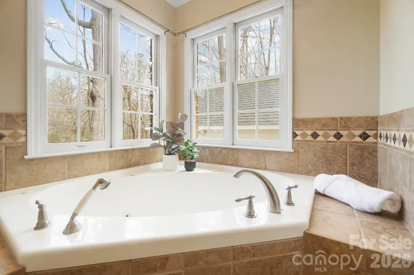 a bath tub sitting in a bathroom next to a window
