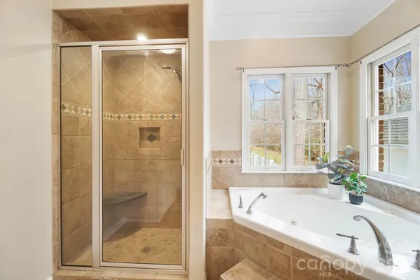 a bathroom with a tub and shower