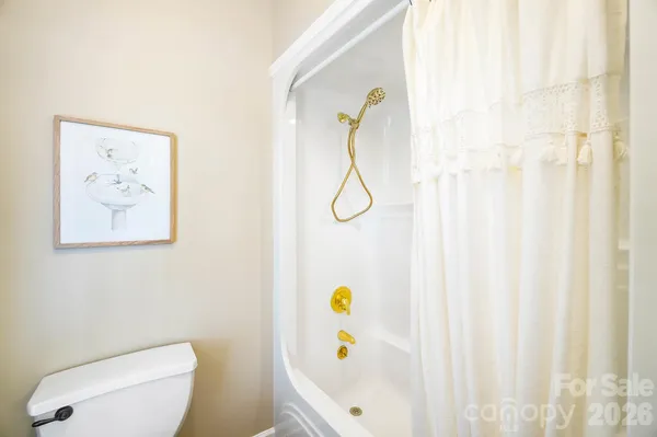 a bathroom with a shower and a toilet