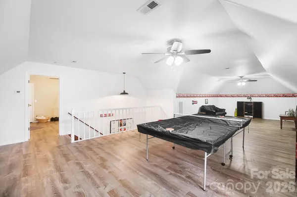 a kitchen with a stove a chandelier and a table