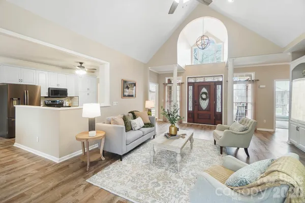a living room with furniture a table and decor