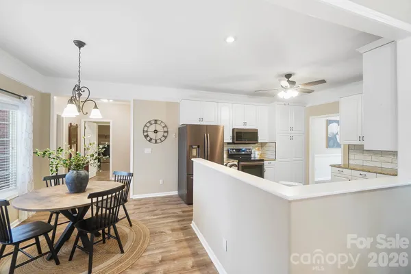 a large kitchen with a table and chairs