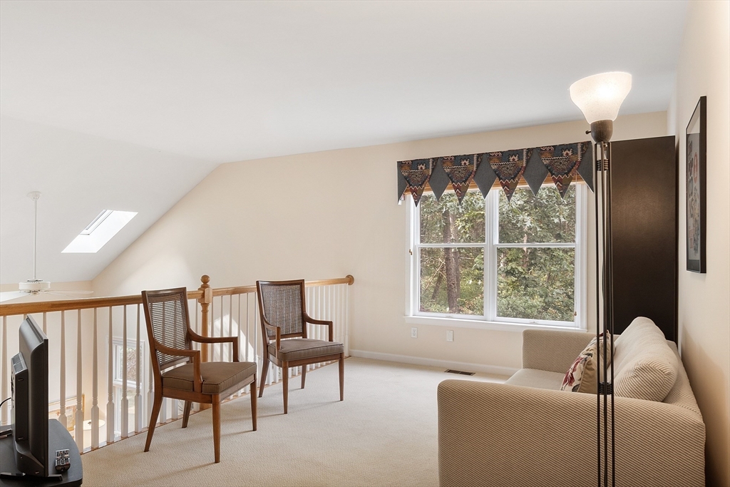 5 Chestnut Lane, Unit 5 Bedford, MA 01730 - Photo 19 of 34 a living room with furniture and a large window