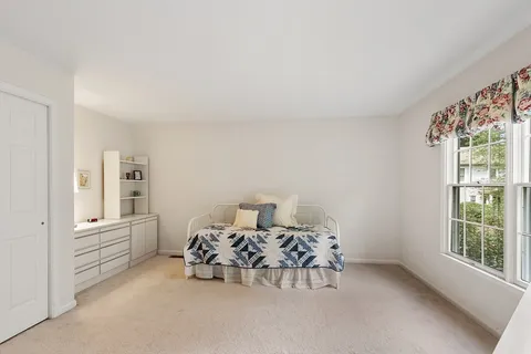 a bedroom with furniture and window