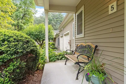 a view of a two chairs in the balcony