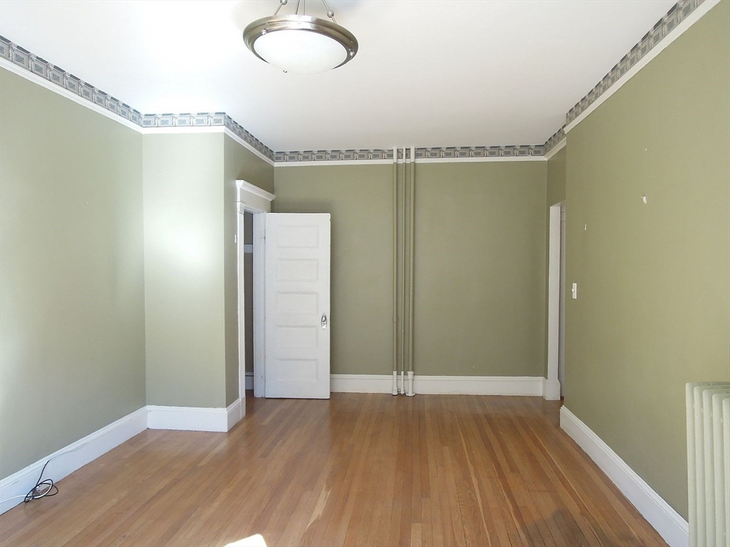 8 Garrison Street, Unit 209 Boston, MA 02116 - Photo 24 of 33 a view of a big room with wooden floor and windows