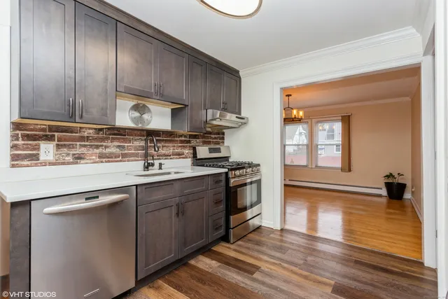 a kitchen with stainless steel appliances granite countertop a sink stove and cabinets