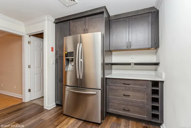 a metallic refrigerator freezer sitting in a kitchen