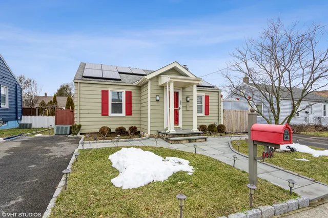 a front view of a house with yard and seating area