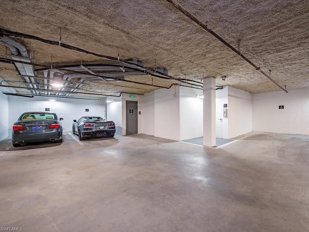 490 5th Street South, Unit 101 Naples, FL 34102 - Photo 32 of 34 a view of parking garage with cars
