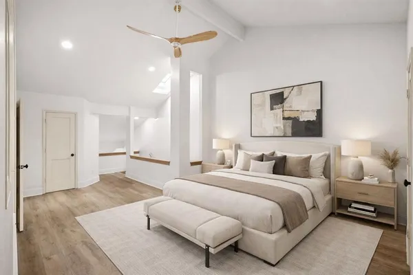 a bedroom with a large bed and a chandelier