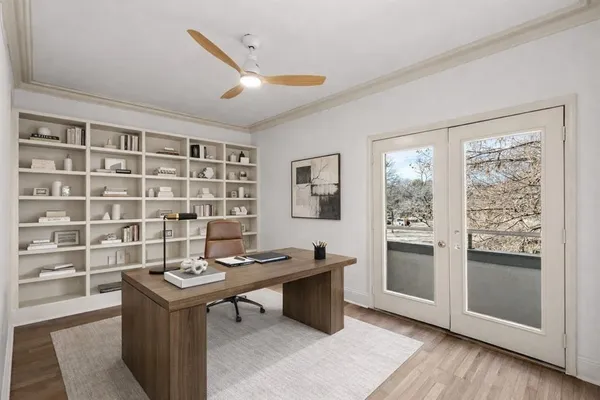 a view of a workspace with furniture and a window