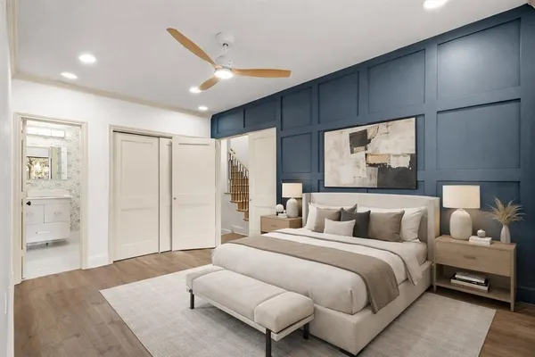a bedroom with a large bed and a couch