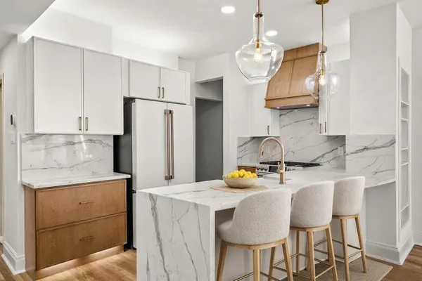 a kitchen with stainless steel appliances granite countertop a sink refrigerator and cabinets