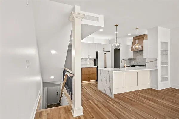 a open kitchen with white cabinets and stainless steel appliances