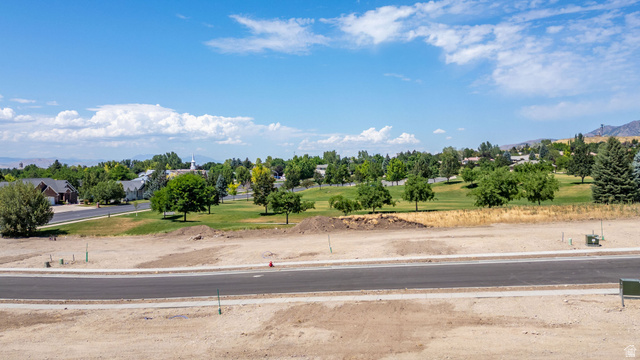 1473 Red Fox Court, Unit 4 Logan, UT 84321 - Photo 15 of 19 Expansive land parcel featuring a paved road, utility boxes, and clear development potential
