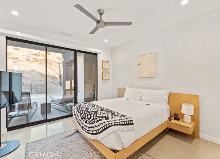 8175 Fox Trail Yucca Valley, CA 92284 - Photo 29 of 75 a bedroom with a bed and a large window