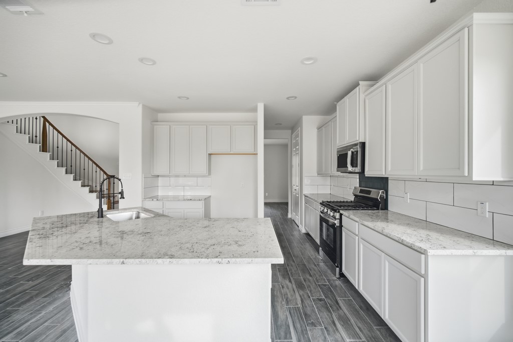 16503 Boston Post Road Cypress, TX 77429 - Photo 14 of 44 a kitchen with granite countertop a sink a counter top space stainless steel appliances and cabinets