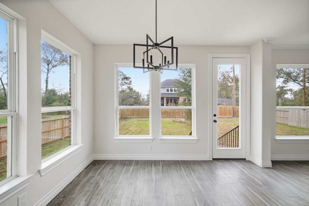 16503 Boston Post Road Cypress, TX 77429 - Photo 18 of 44 a view of an empty room with a window and wooden floor