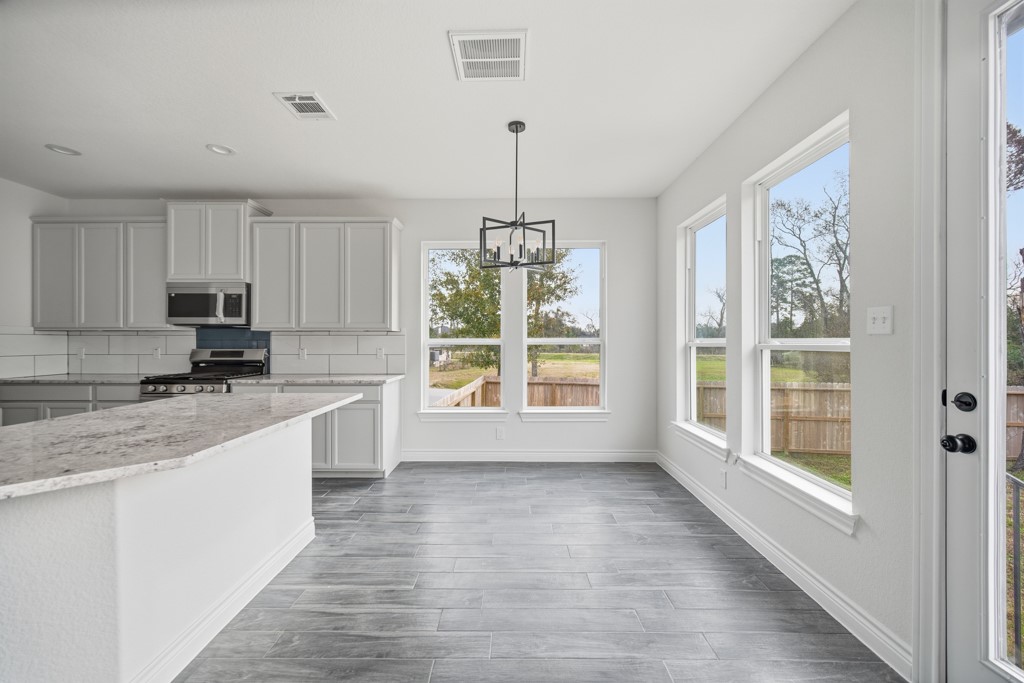 16503 Boston Post Road Cypress, TX 77429 - Photo 19 of 44 a large kitchen with granite countertop a large window