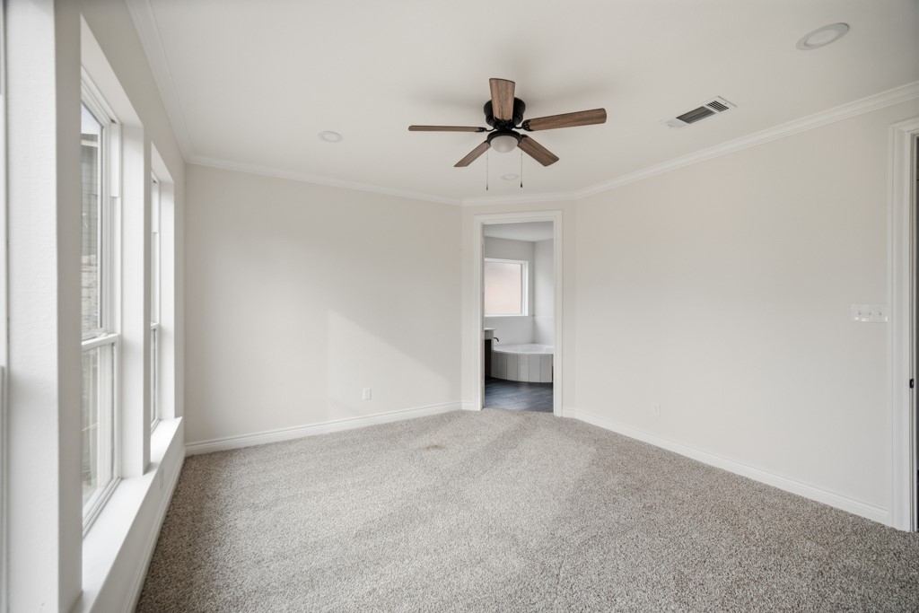 16503 Boston Post Road Cypress, TX 77429 - Photo 21 of 44 a view of a room with a ceiling fan and window