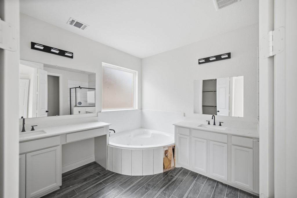 16503 Boston Post Road Cypress, TX 77429 - Photo 24 of 44 a bathroom with a double vanity sink and mirror