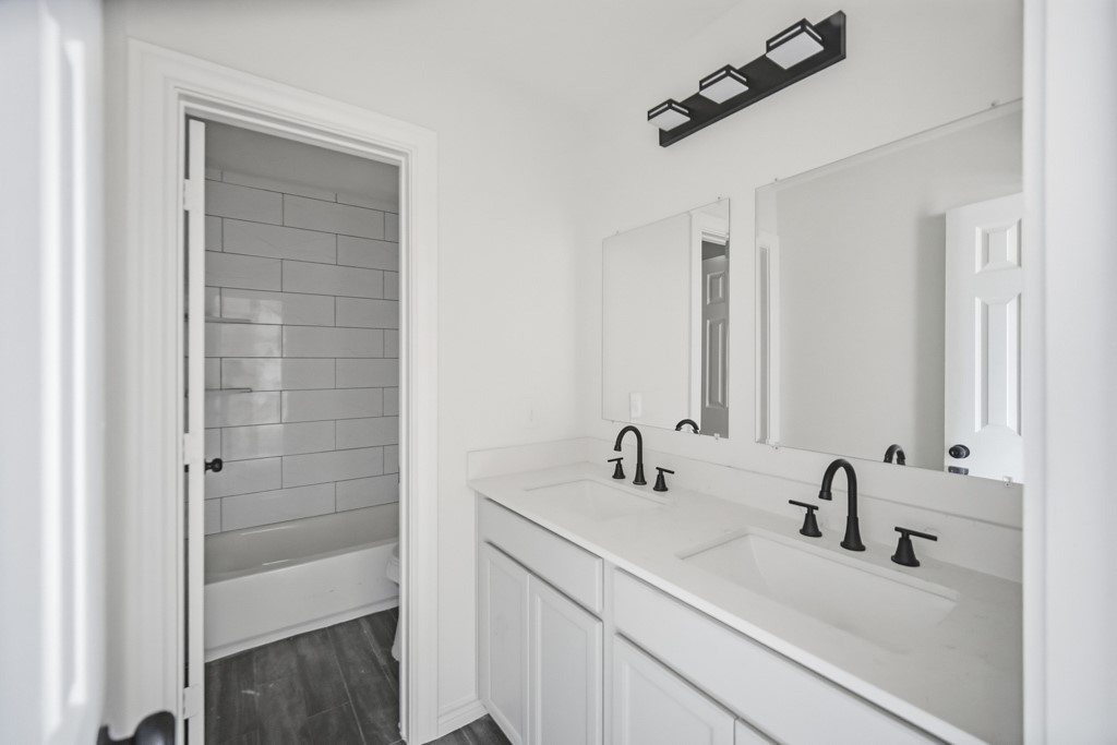 16503 Boston Post Road Cypress, TX 77429 - Photo 32 of 44 a bathroom with a sink and a mirror