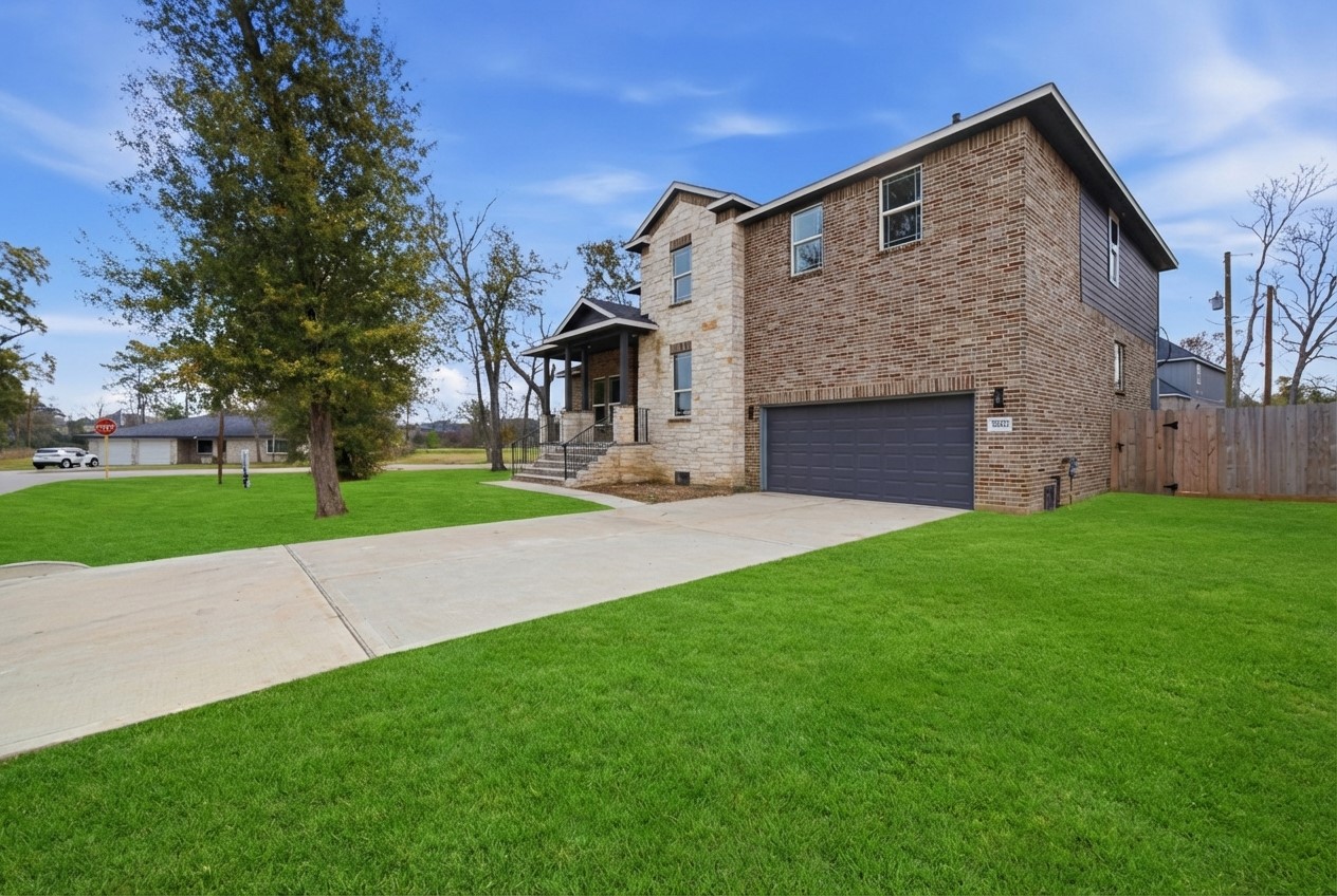 16503 Boston Post Road Cypress, TX 77429 - Photo 42 of 44 a front view of a house with a yard and garage