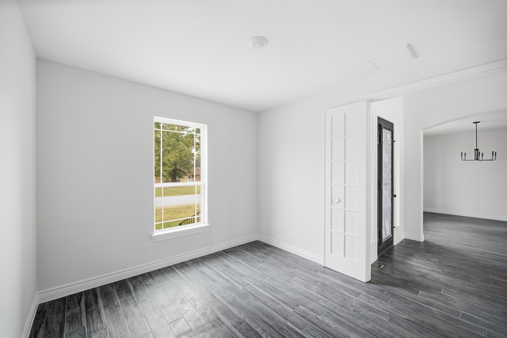 16503 Boston Post Road Cypress, TX 77429 - Photo 5 of 44 an empty room with wooden floor and a window