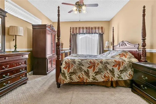 a bed sitting in a room next to a window