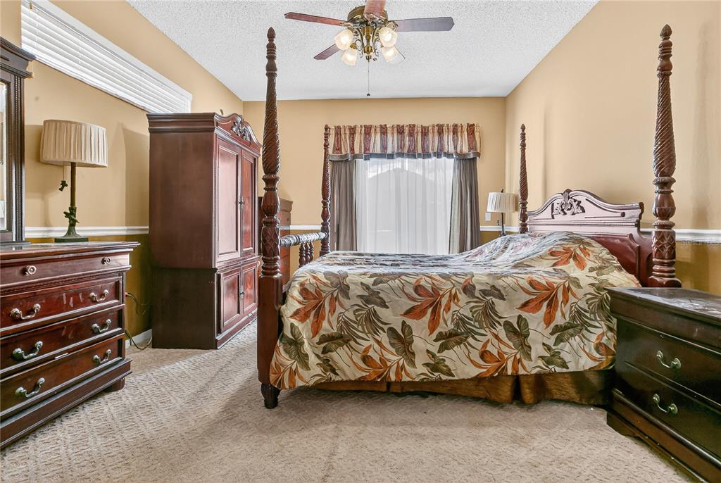 223 Tavestock Loop Winter Springs, FL 32708 - Photo 13 of 27 a bed sitting in a room next to a window