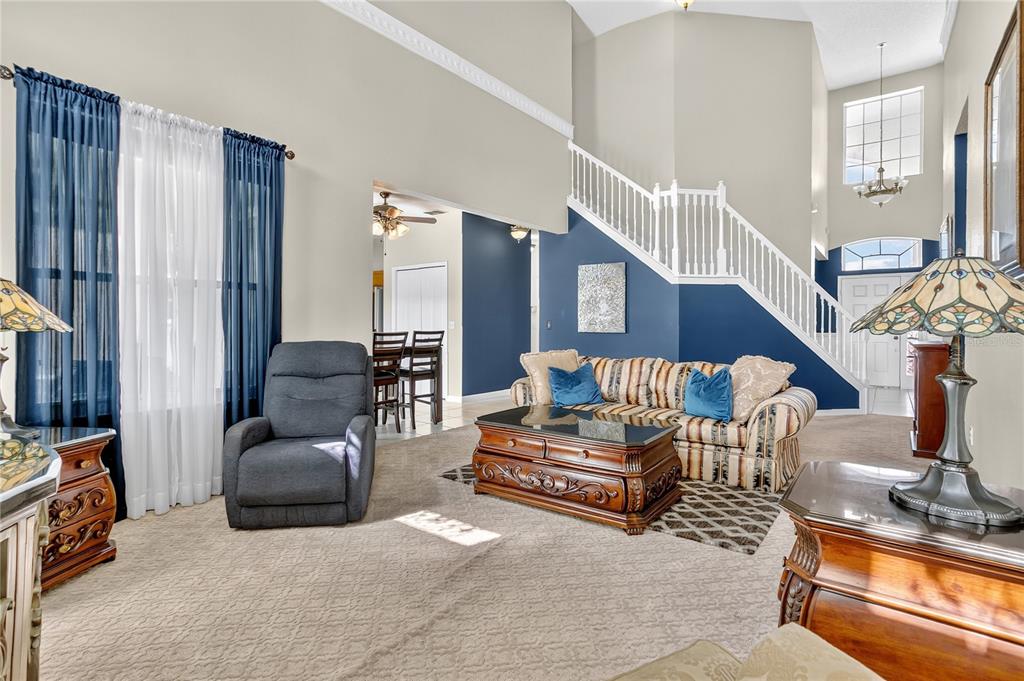 223 Tavestock Loop Winter Springs, FL 32708 - Photo 3 of 27 a living room with furniture and a flat screen tv