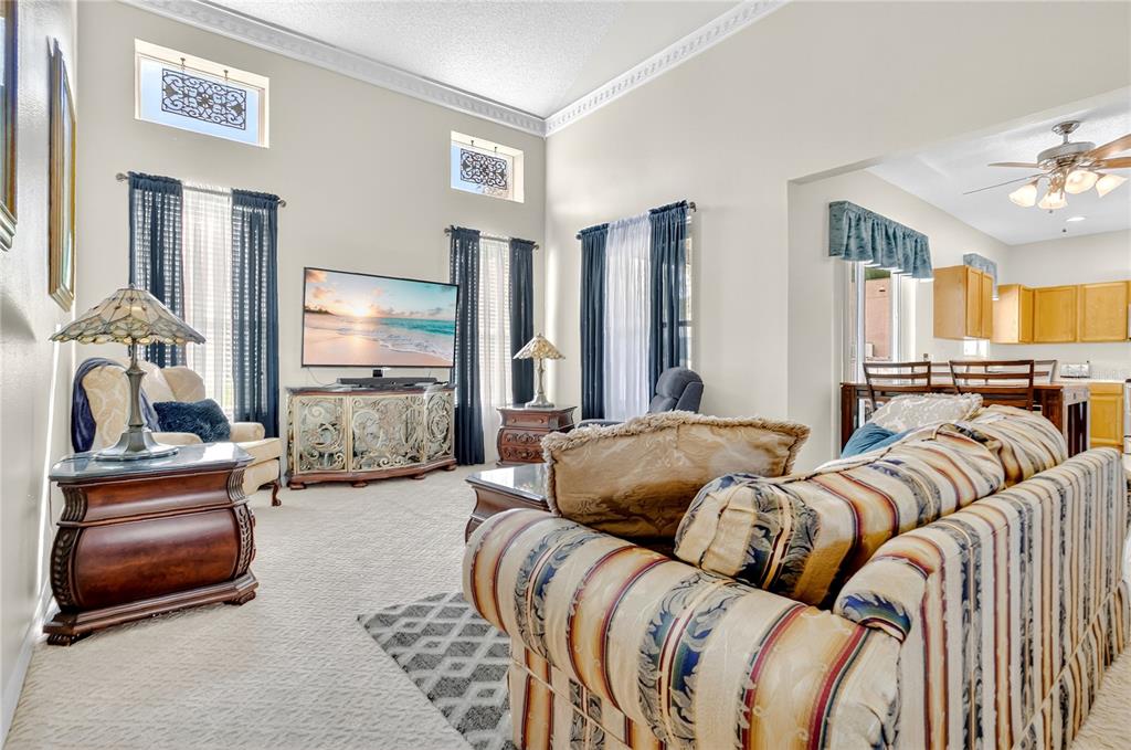 223 Tavestock Loop Winter Springs, FL 32708 - Photo 5 of 27 a bedroom with furniture and a chandelier