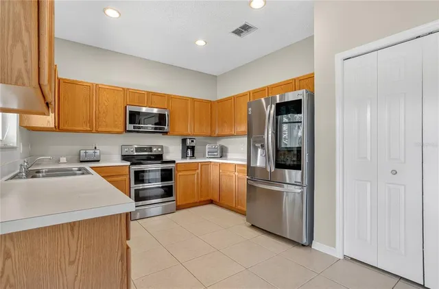 a kitchen with stainless steel appliances a refrigerator stove and sink