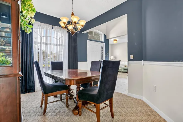 a view of a dining room with furniture and chandelier