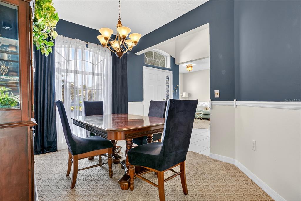 223 Tavestock Loop Winter Springs, FL 32708 - Photo 9 of 27 a view of a dining room with furniture and chandelier