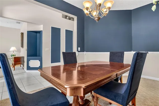 a dining room with furniture and a chandelier