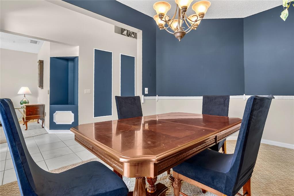 223 Tavestock Loop Winter Springs, FL 32708 - Photo 10 of 27 a dining room with furniture and a chandelier