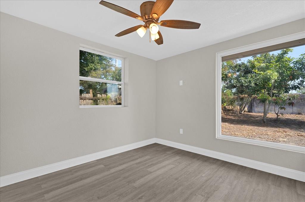 923 Ferndell Road Orlando, FL 32808 - Photo 18 of 42 a view of a big room with wooden floor and a window